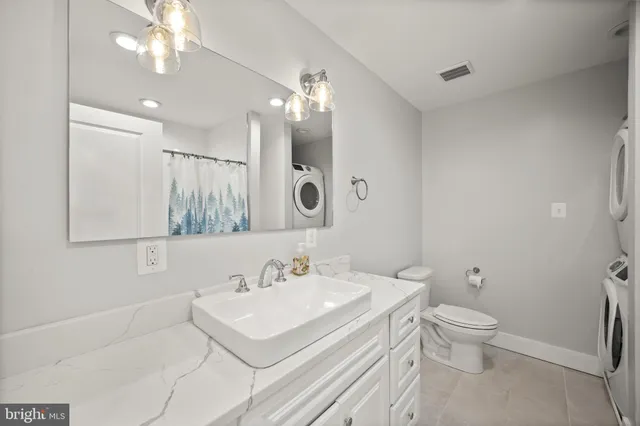 a bathroom with a sink vanity and a mirror
