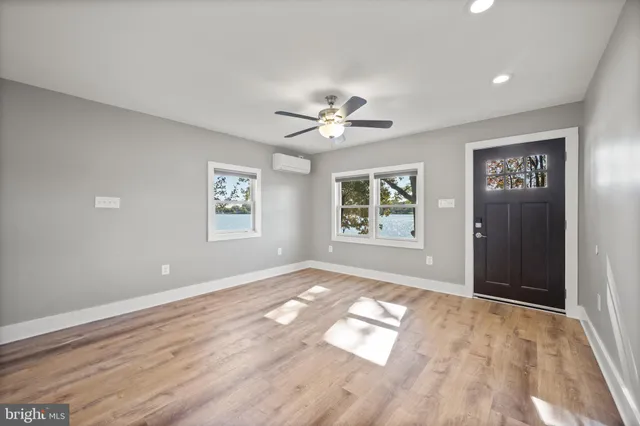a workspace with wooden floor and a window