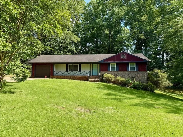 a front view of a house with a garden