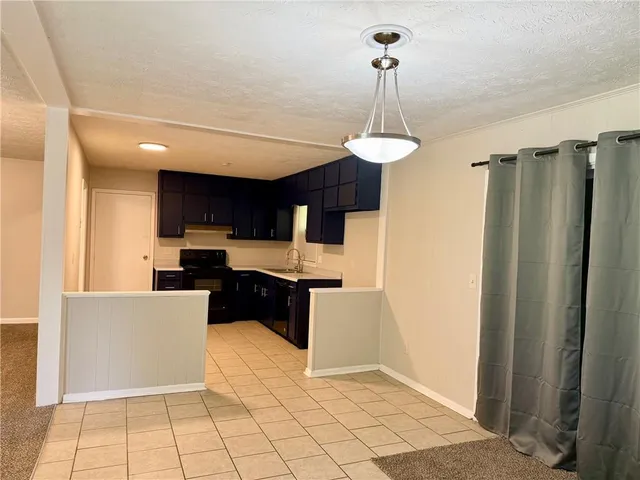 a kitchen with stainless steel appliances a refrigerator sink and microwave