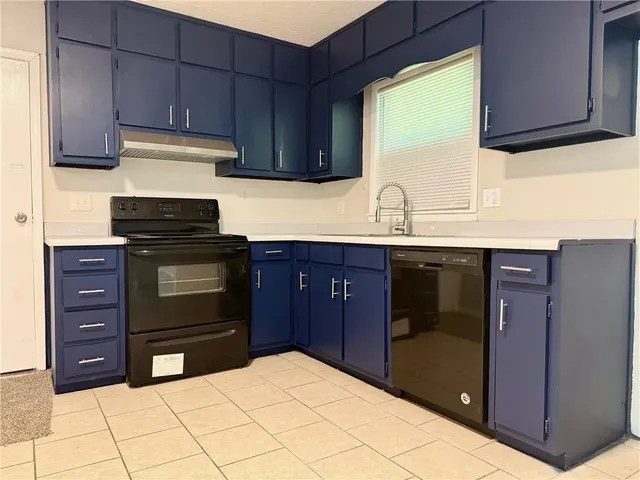 a kitchen with a cabinets and appliances