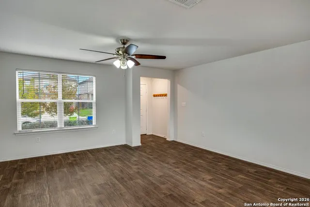 wooden floor in an empty room with a window