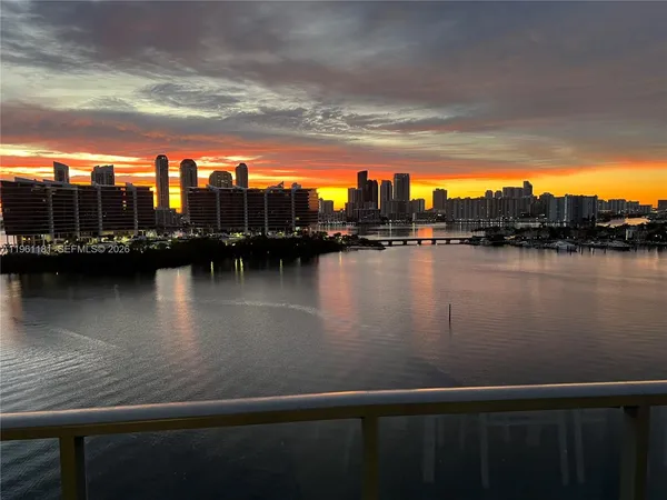 a view of ocean view with boats and trees in the background