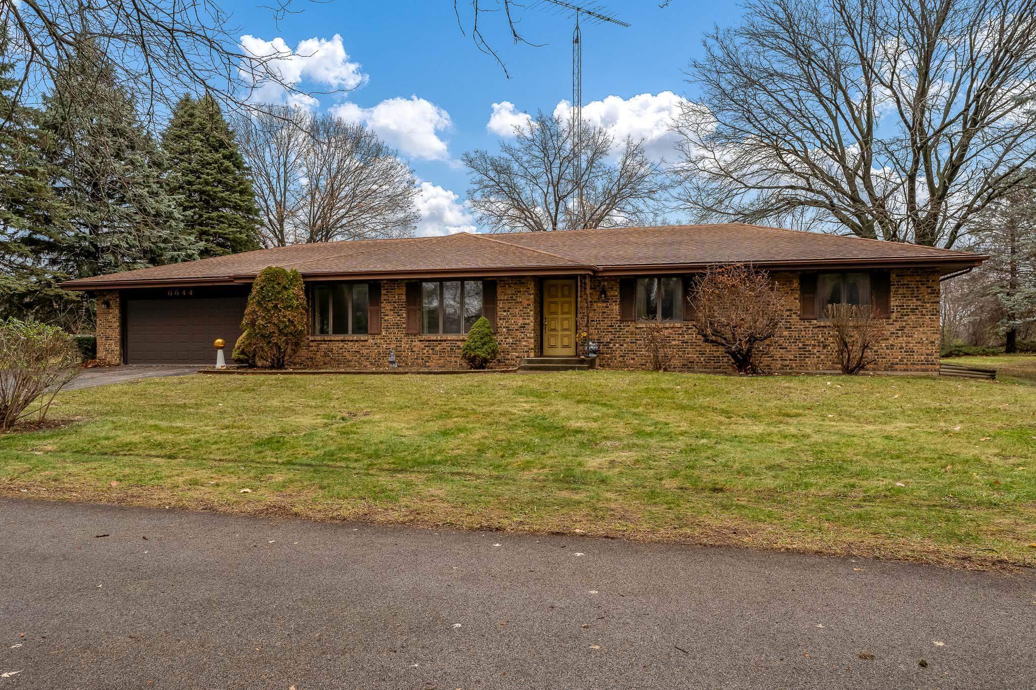 6644 Belvidere Road Roscoe, IL 61073 - Photo 1 of 42 a front view of a house with large yard