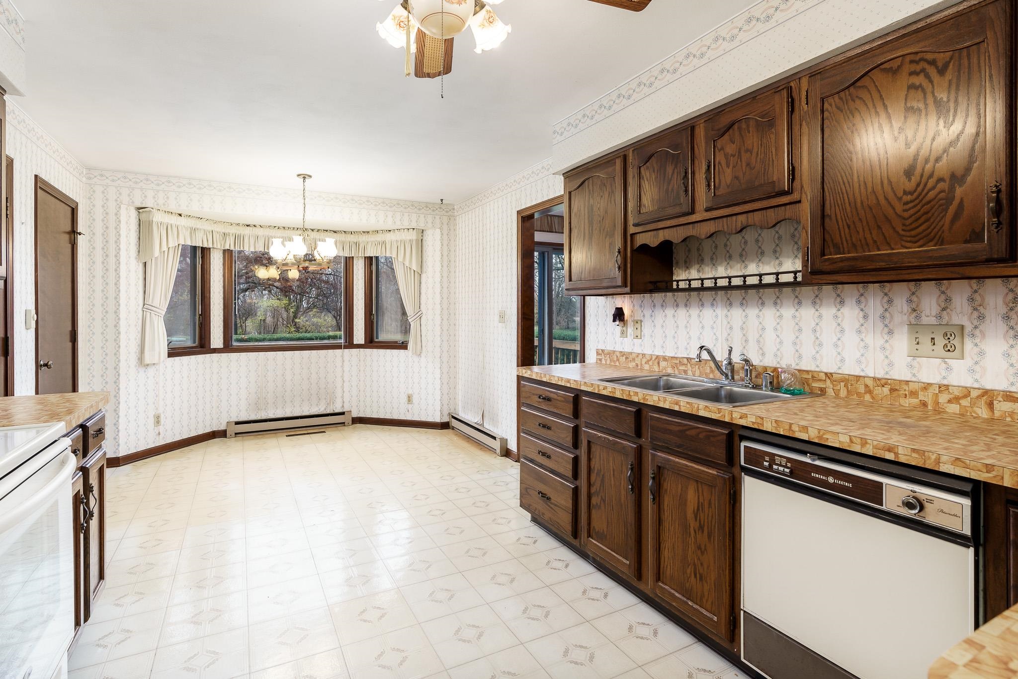 6644 Belvidere Road Roscoe, IL 61073 - Photo 17 of 42 a kitchen with stainless steel appliances granite countertop a sink stove and cabinets