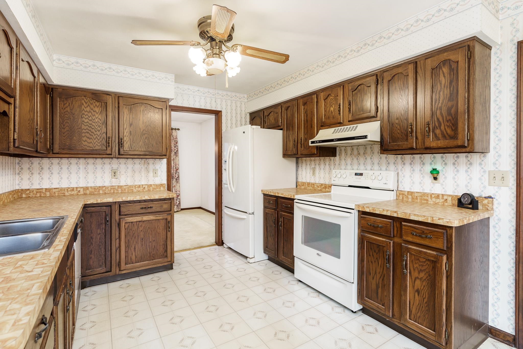 6644 Belvidere Road Roscoe, IL 61073 - Photo 19 of 42 a kitchen with granite countertop a sink stainless steel appliances and cabinets