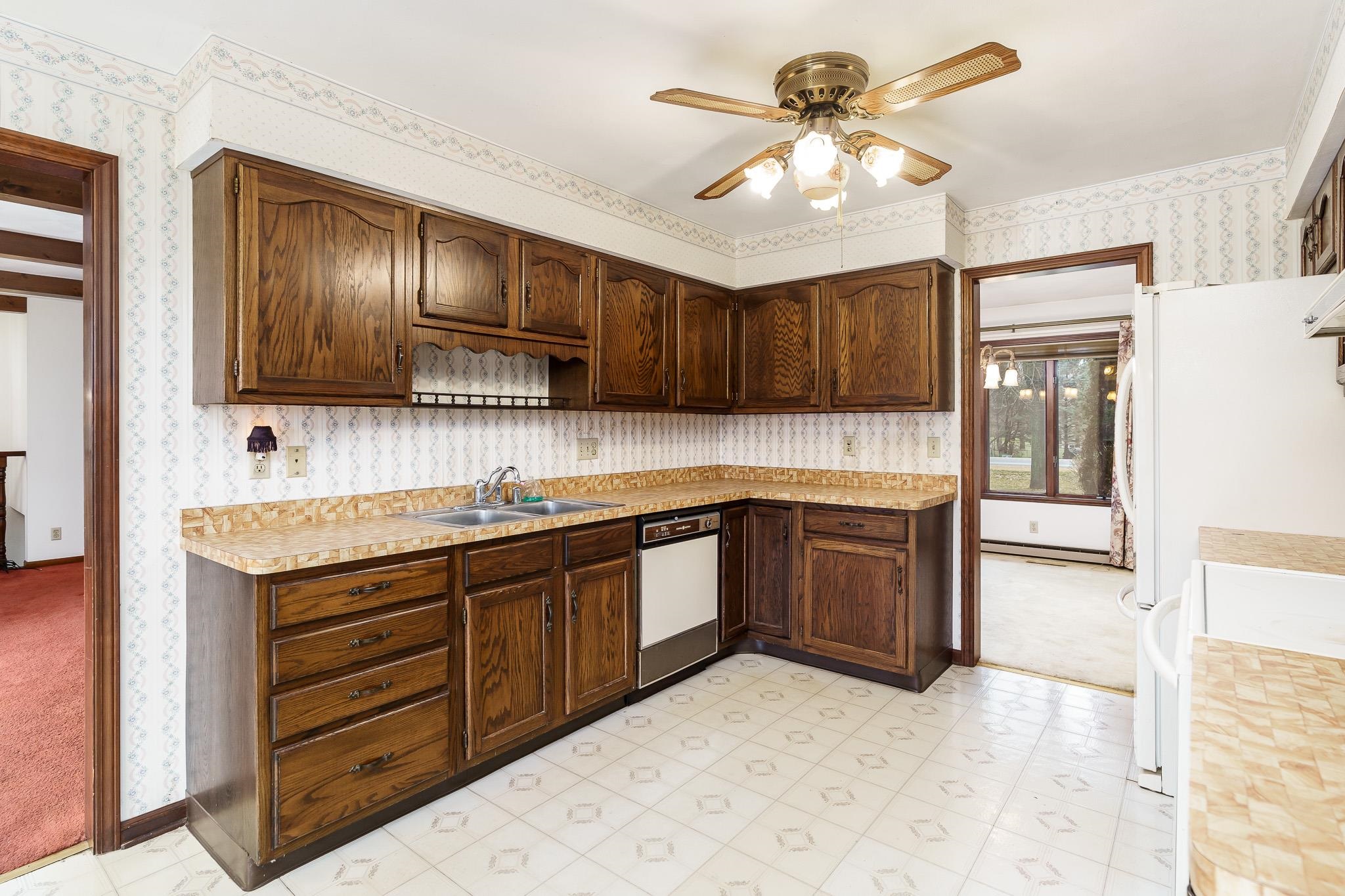6644 Belvidere Road Roscoe, IL 61073 - Photo 20 of 42 a kitchen with granite countertop wooden cabinets a stove a sink and a oven