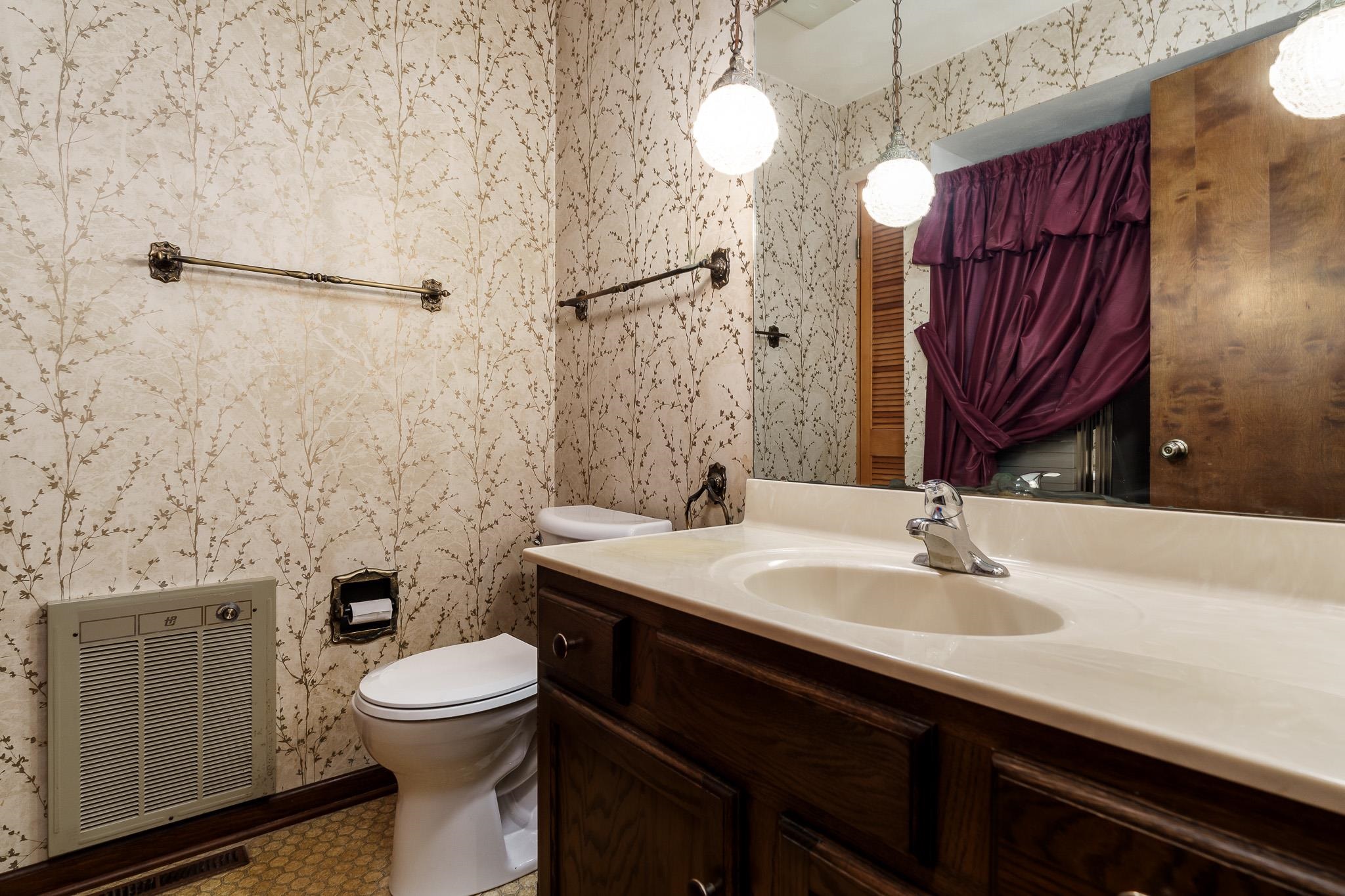 6644 Belvidere Road Roscoe, IL 61073 - Photo 27 of 42 a bathroom with a sink a toilet a mirror and shower