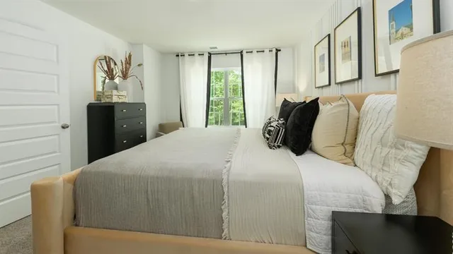 a bedroom with a bed and a window