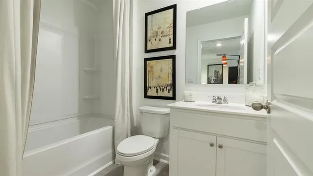 a bathroom with a toilet a sink a mirror and a bathtub