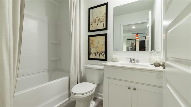 1392 Sweetshrub Place, Unit 1392 Austell, GA 30168 - Photo 26 of 28 a bathroom with a toilet a sink a mirror and a bathtub