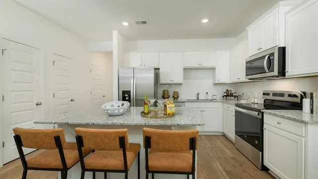 a kitchen with sink cabinets and stainless steel appliances