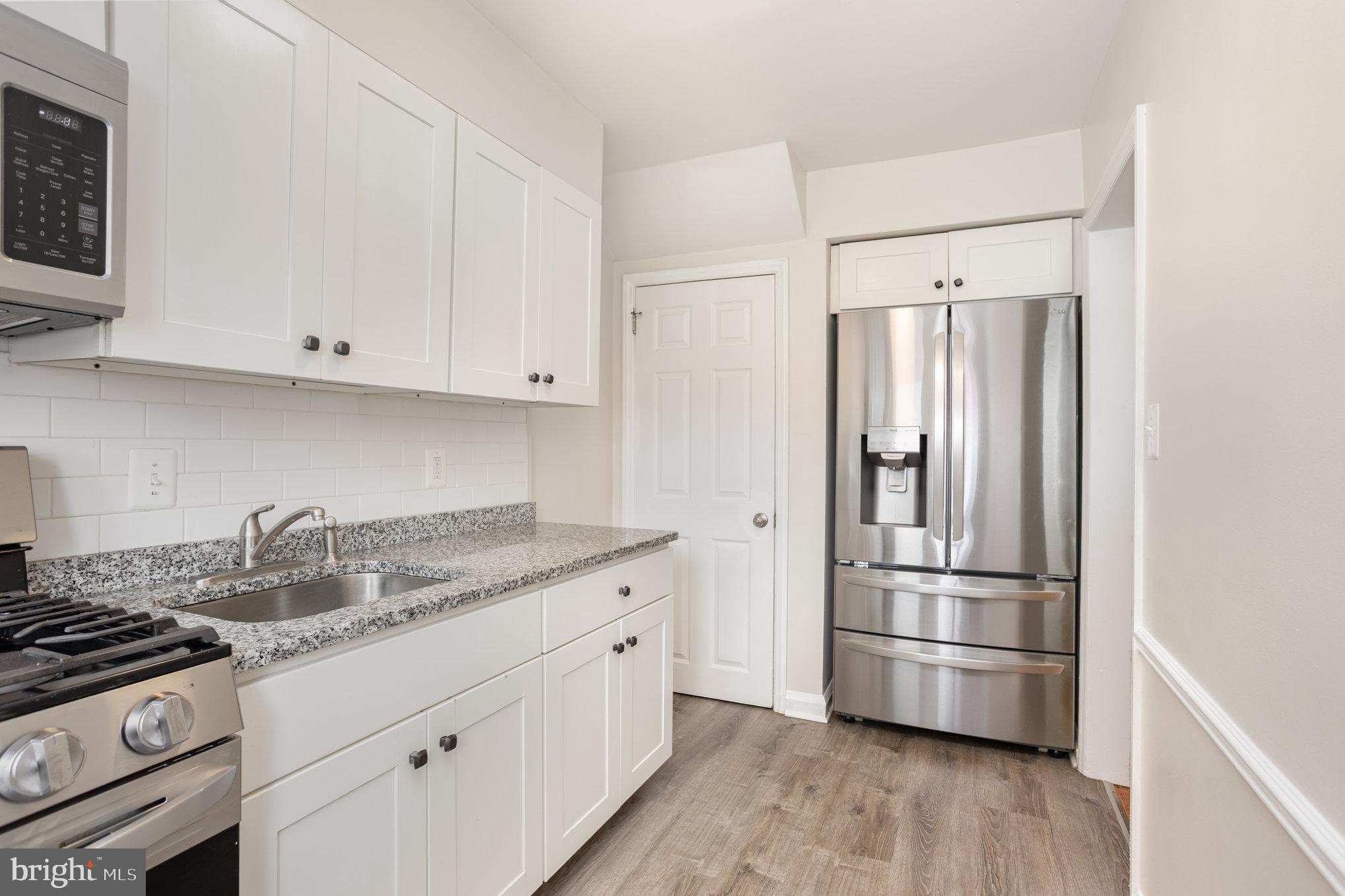 53 South Hawthorne Road Middle River, MD 21220 - Photo 10 of 29 a kitchen with stainless steel appliances granite countertop a refrigerator sink and stove