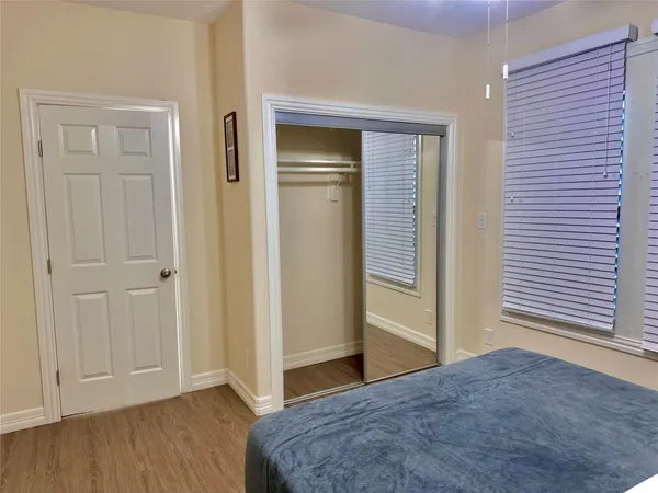 a bedroom with a bed and a bathroom