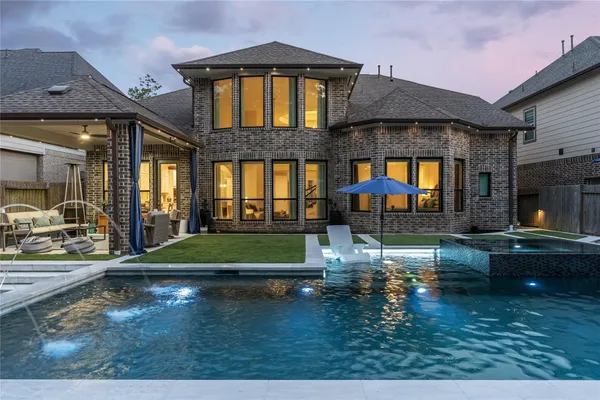 a swimming pool view with a outdoor seating