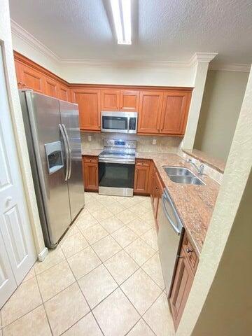 4105 Napoli Lake Drive Riviera Beach, FL 33410 - Photo 11 of 14 a kitchen with stainless steel appliances granite countertop a refrigerator and a stove