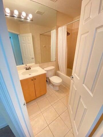 4105 Napoli Lake Drive Riviera Beach, FL 33410 - Photo 12 of 14 a bathroom with a sink a toilet and shower