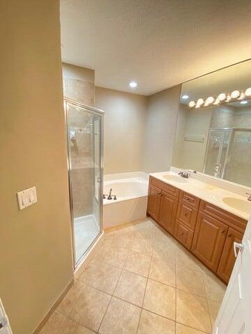 4105 Napoli Lake Drive Riviera Beach, FL 33410 - Photo 13 of 14 a bathroom with a tub sink vanity granite and shower