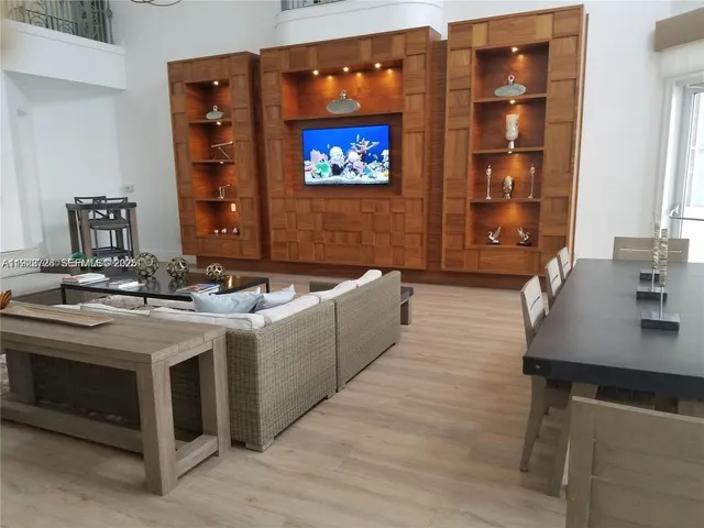 a large white kitchen with a sink and a stove with a dining table