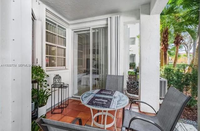 a table and chairs in front of a house