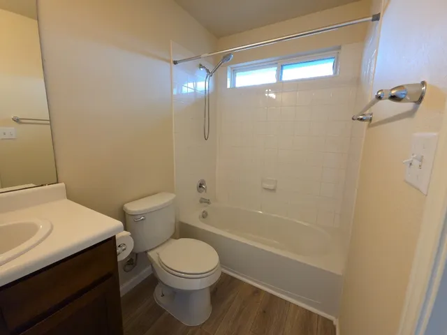 a bathroom with a toilet a sink and a shower