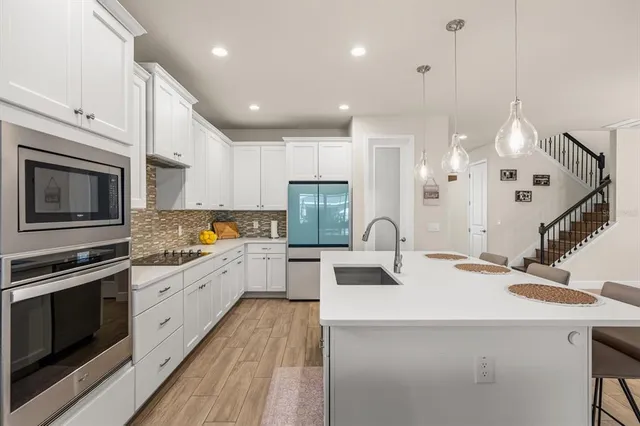 a kitchen with a sink stove and microwave