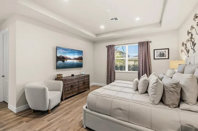 a bedroom with two beds and a flat screen tv