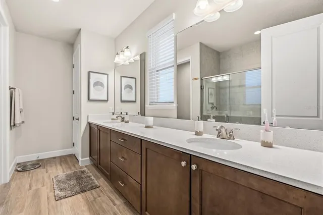 a spacious bathroom with a double vanity sink mirror and double