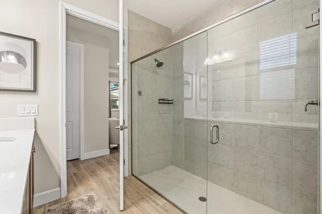 a bathroom with a shower and a sink