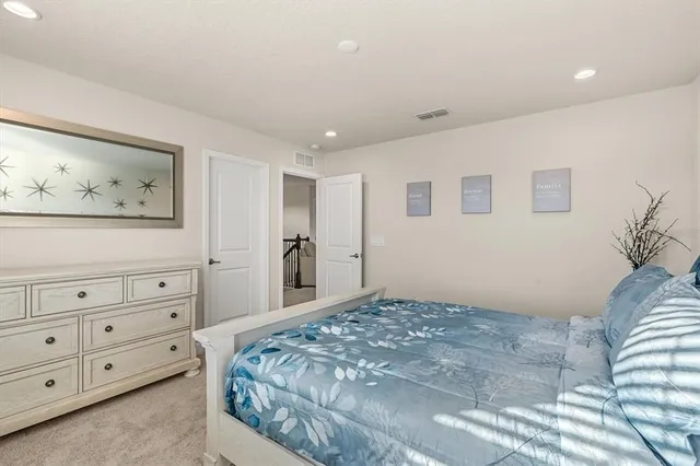 a bedroom with a bed and a painting on the wall