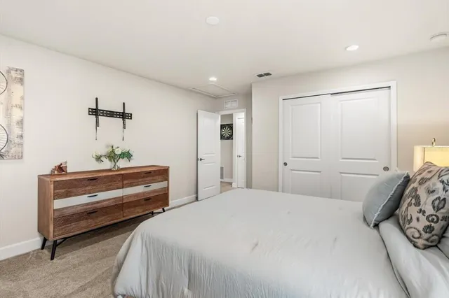 a bedroom with a bed and a mirror