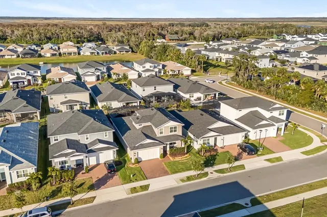 an aerial view of residential houses with outdoor space