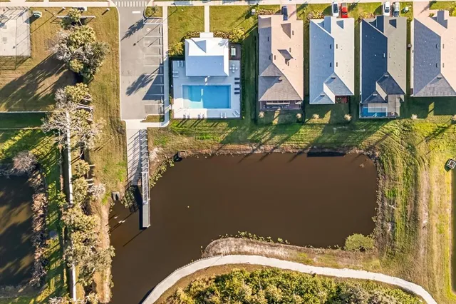 an aerial view of residential houses with outdoor space