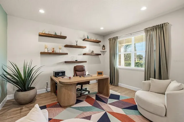 a living room with furniture and a potted plant