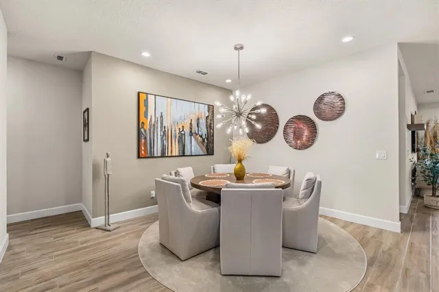 a view of a dining room with a table and chairs
