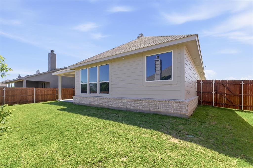 1225 Sabine River Lane Springtown, TX 76082 - Photo 23 of 25 Rear view of property with a shingled roof, a fenced backyard, a gate, and a patio area