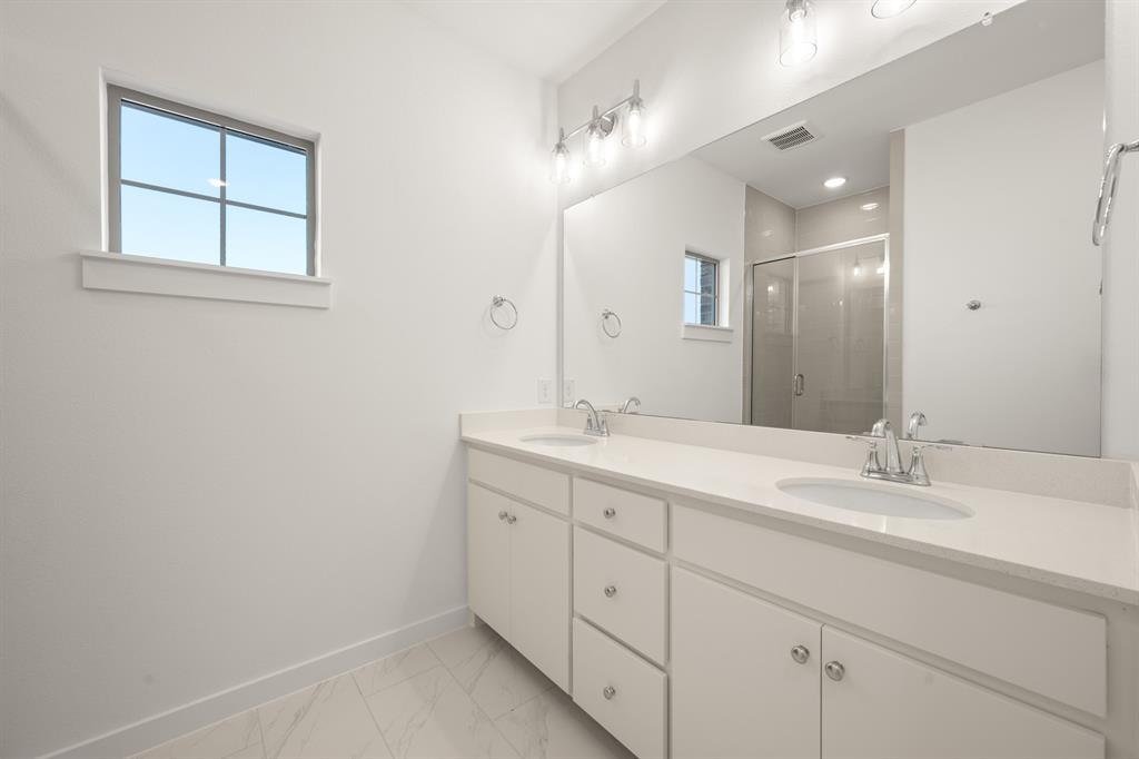 4619 Hawks Trail Oak Point, TX 75068 - Photo 29 of 40 a bathroom with a double vanity sink and a mirror
