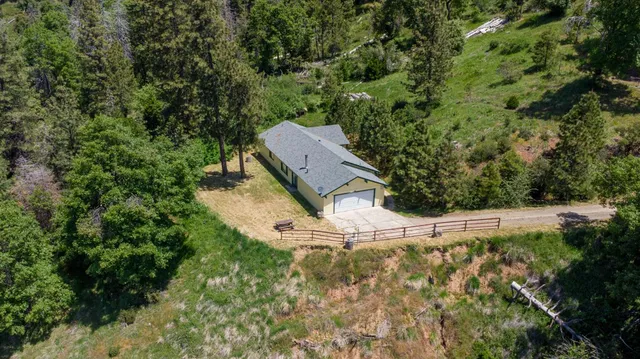 an aerial view of a house with a yard