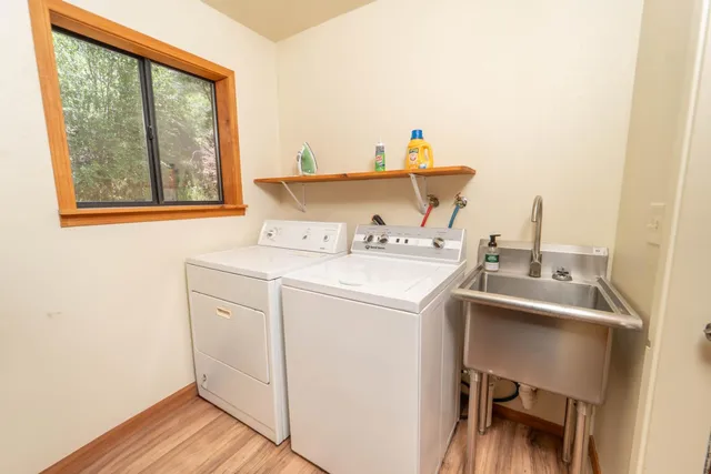 a bedroom with two beds and a desk