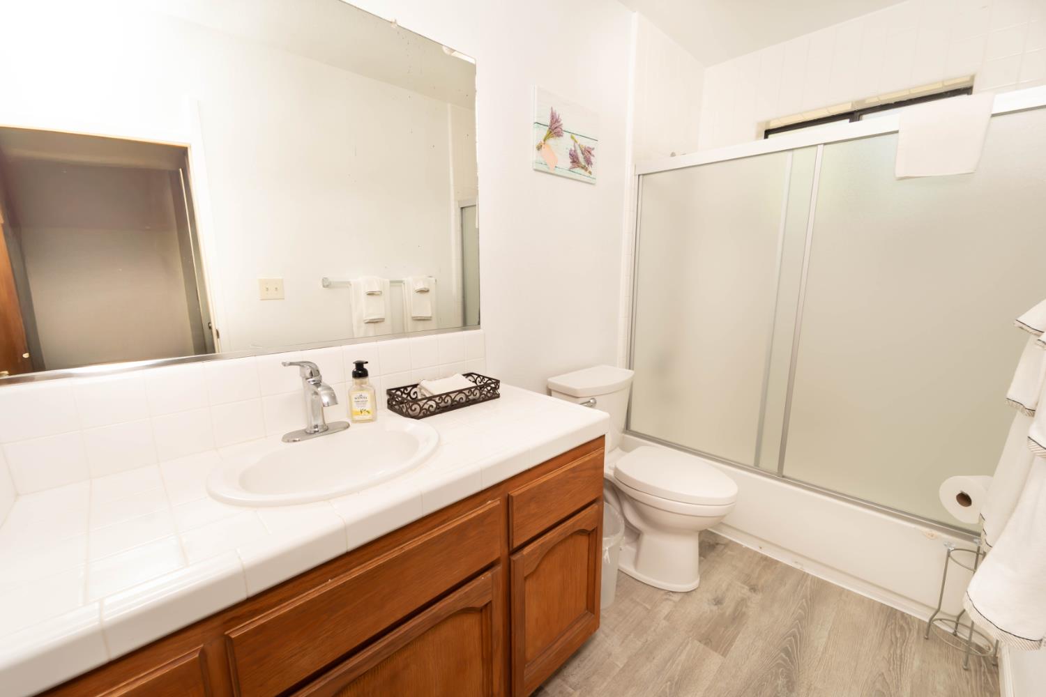 52865 Highway 245 Miramonte, CA 93641 - Photo 15 of 29 a bathroom with a sink a toilet and shower