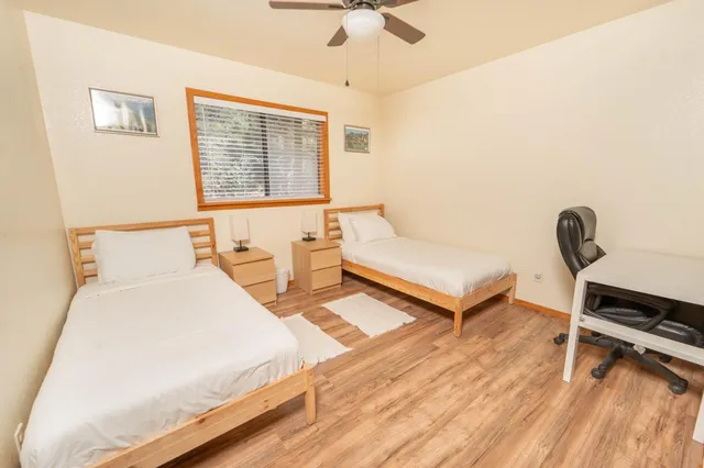 a bedroom with a bed and a desk