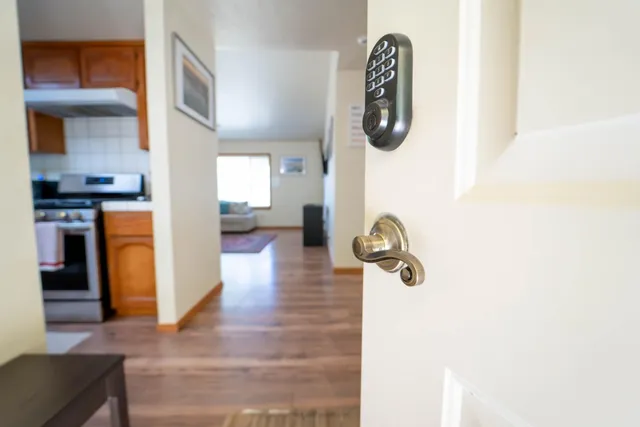 a hallway with wooden floor and windows