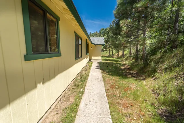 a backyard of a house with table and chairs
