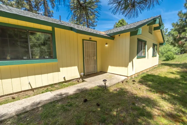 a room with wooden floor pool table and windows