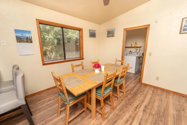 a kitchen with stainless steel appliances kitchen island granite countertop a sink a stove cabinets and wooden floor