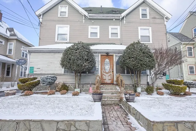 a front view of a house with garden