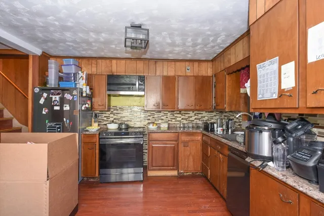 a kitchen with stainless steel appliances granite countertop a sink stove and refrigerator