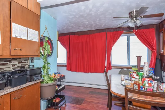 a view of a dining room with furniture and a window