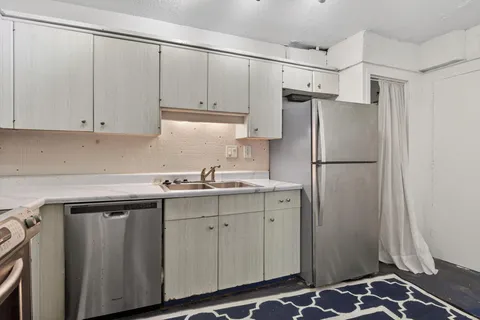 a kitchen with stainless steel appliances a refrigerator and a sink