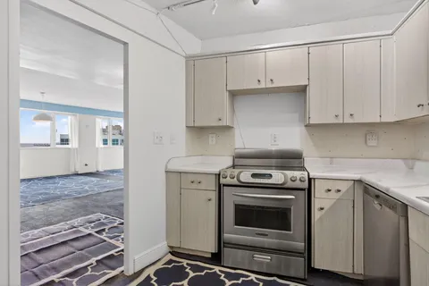 a kitchen with granite countertop a stove and a sink